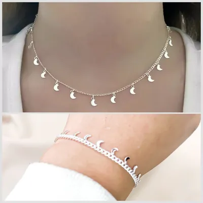 Pescoço com choker de corrente fina e pingentes de lua, e pulso com pulseira de elos e luinhas, ambos prateados
