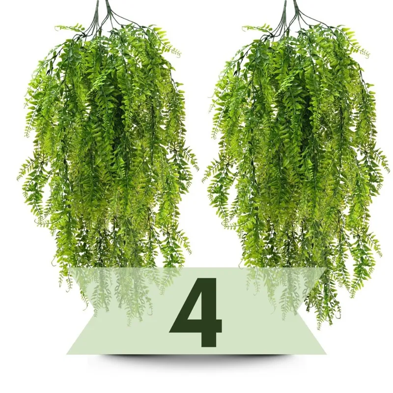 Dois ramos de samambaia artificial verde pendentes, com folhas longas caindo em cascata, sobre fundo branco