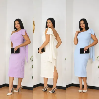 Mulher usando vestido midi tubinho de um ombro só com laço, em três cores: lilás, off-white e azul-claro